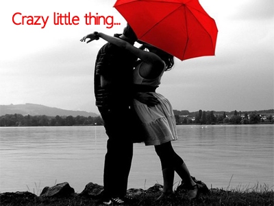 A couple kissing under a red umbrella. Black and white stock photography.